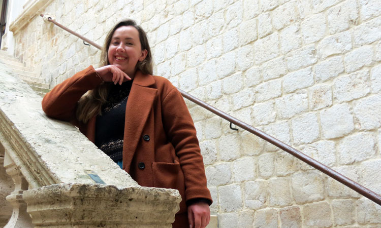 Han Talbot smiling on a stone staircase in Dubrovnik