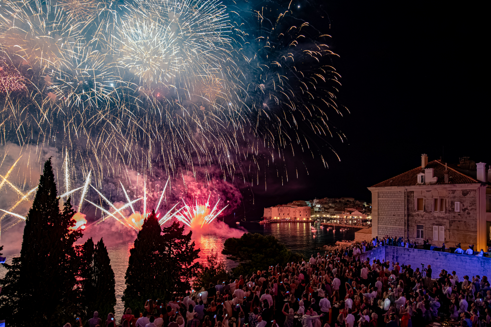Fireworks over the Old Town harbour as crowds watch after the Dubrovnik Summer Festival opening