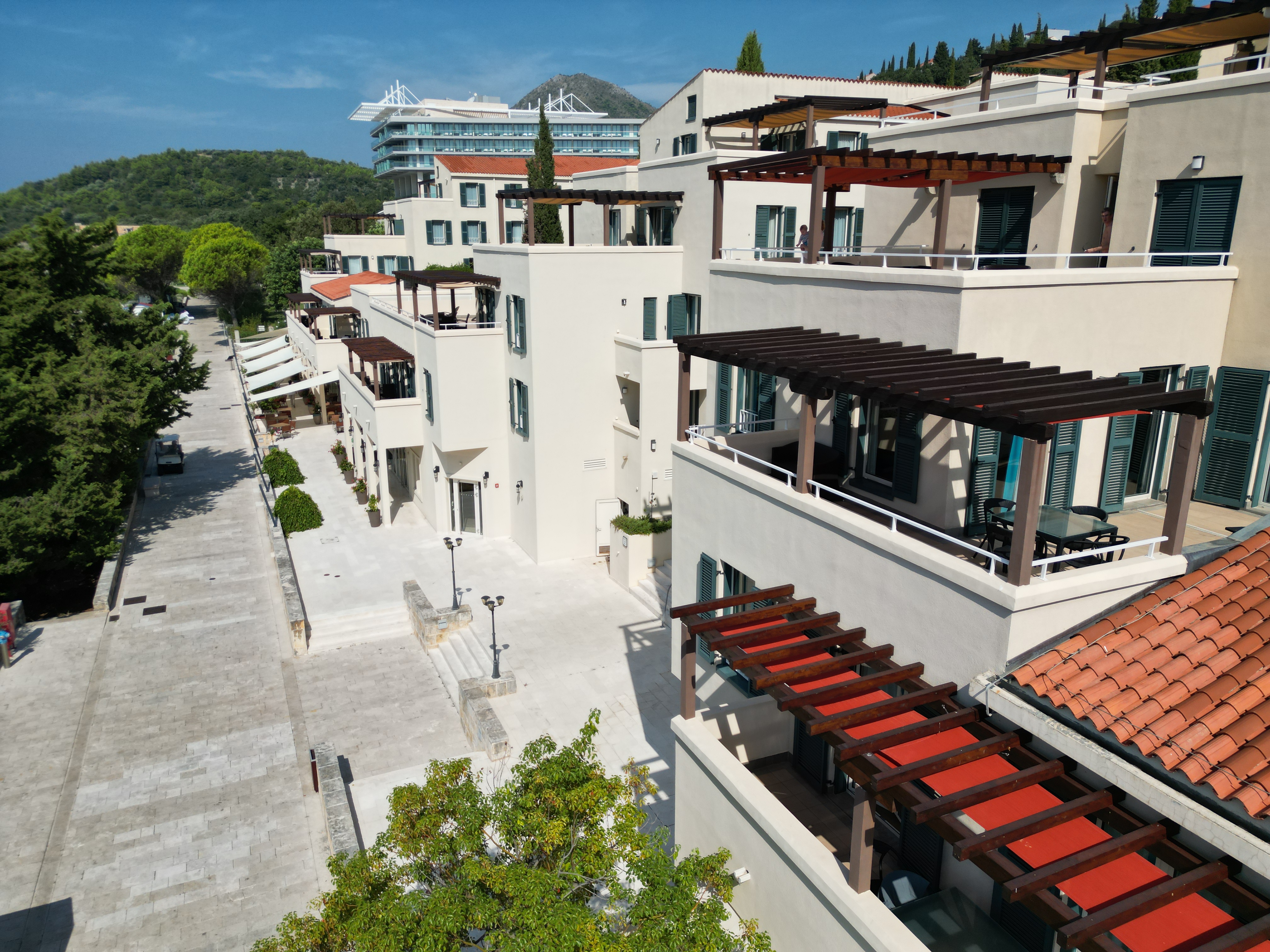 Apartment buildings with pergola terraces beside a paved street at Dubrovnik Sea View Residences