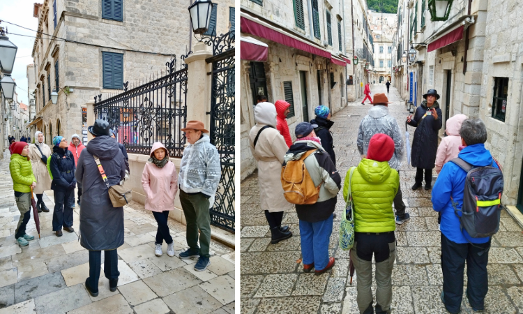 Tour group with a guide on narrow stone streets of Dubrovnik Old Town in winter