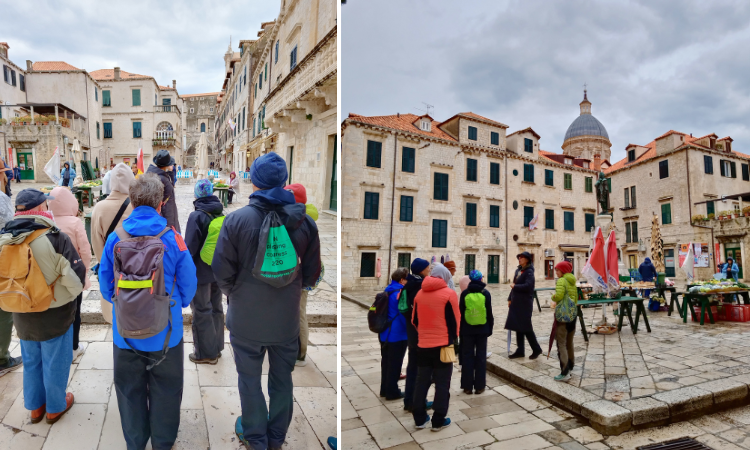 Winter walking tour group exploring the streets and a square of Dubrovnik Old Town