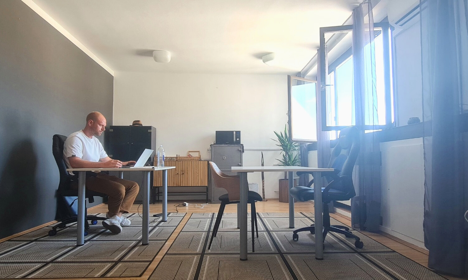 Man working on a laptop in the bright, spacious Dubrovnik co-working space at TUP