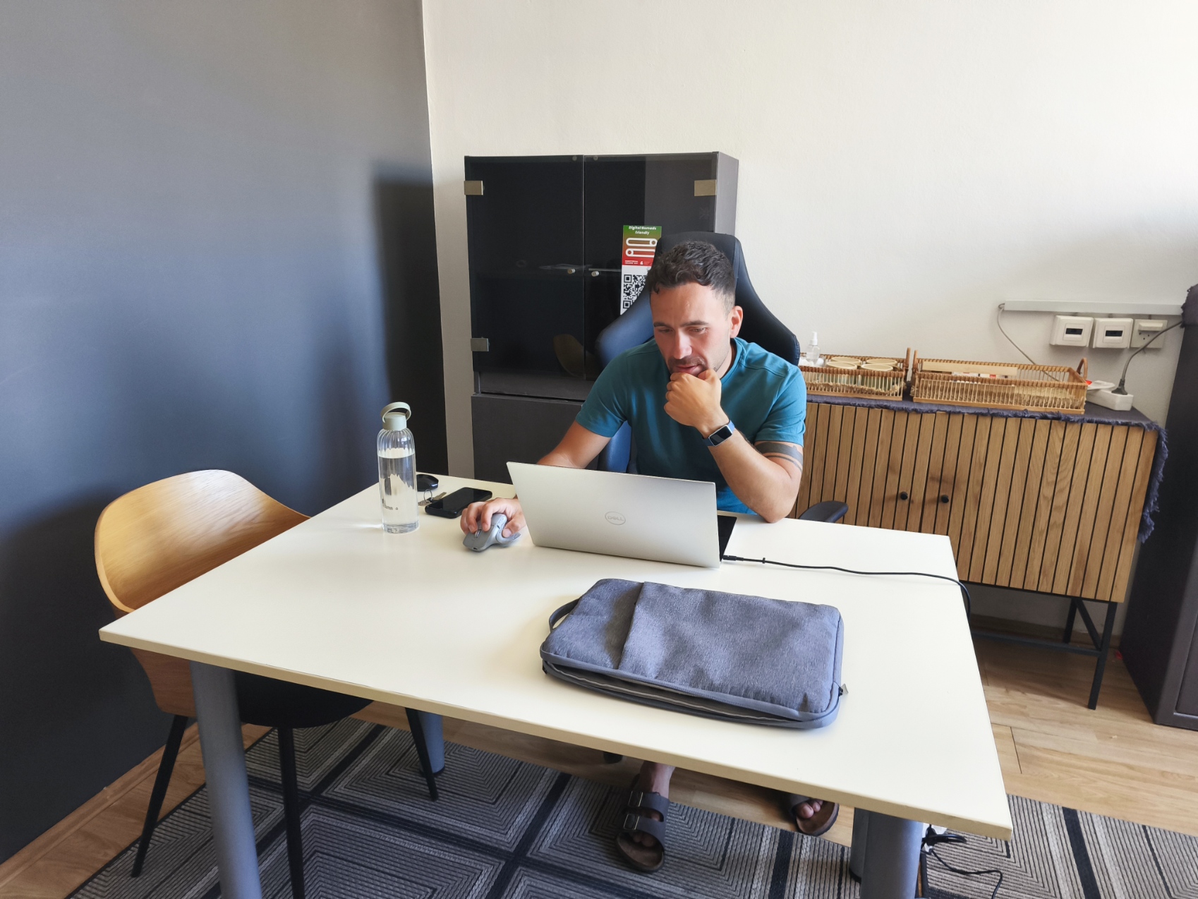 Man working on a laptop at a white desk in the free TUP co-working space in Dubrovnik