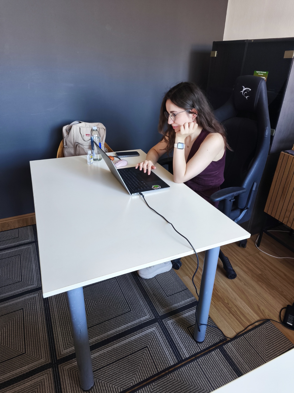 Digital nomad working on a laptop at a white desk in Dubrovnik's free co-working space at TUP
