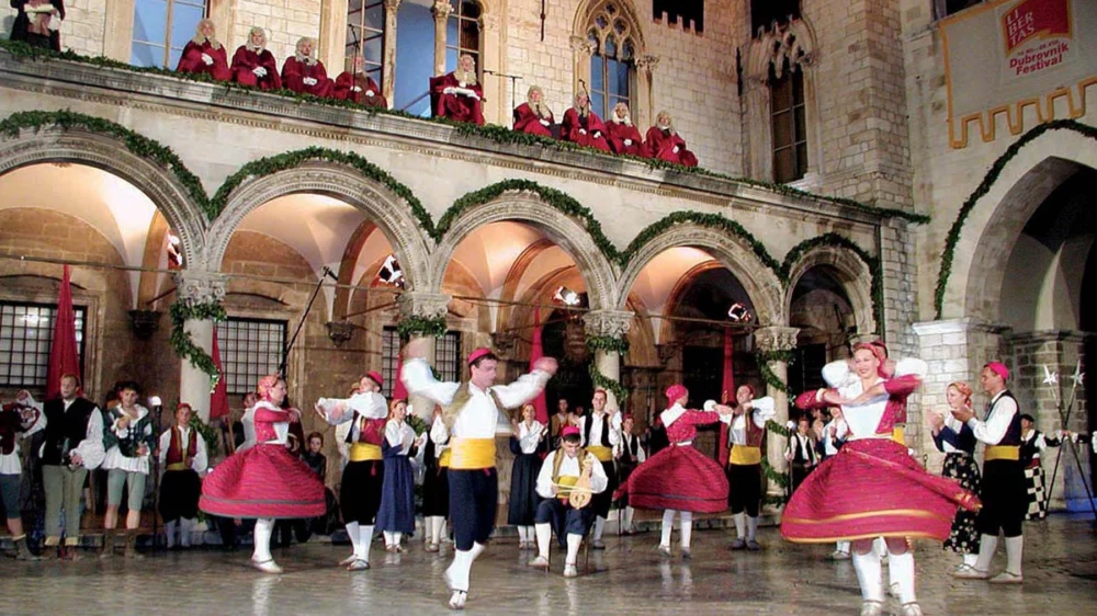 Folk dancers in traditional costume perform in front of Sponza Palace at the Dubrovnik Summer Festival