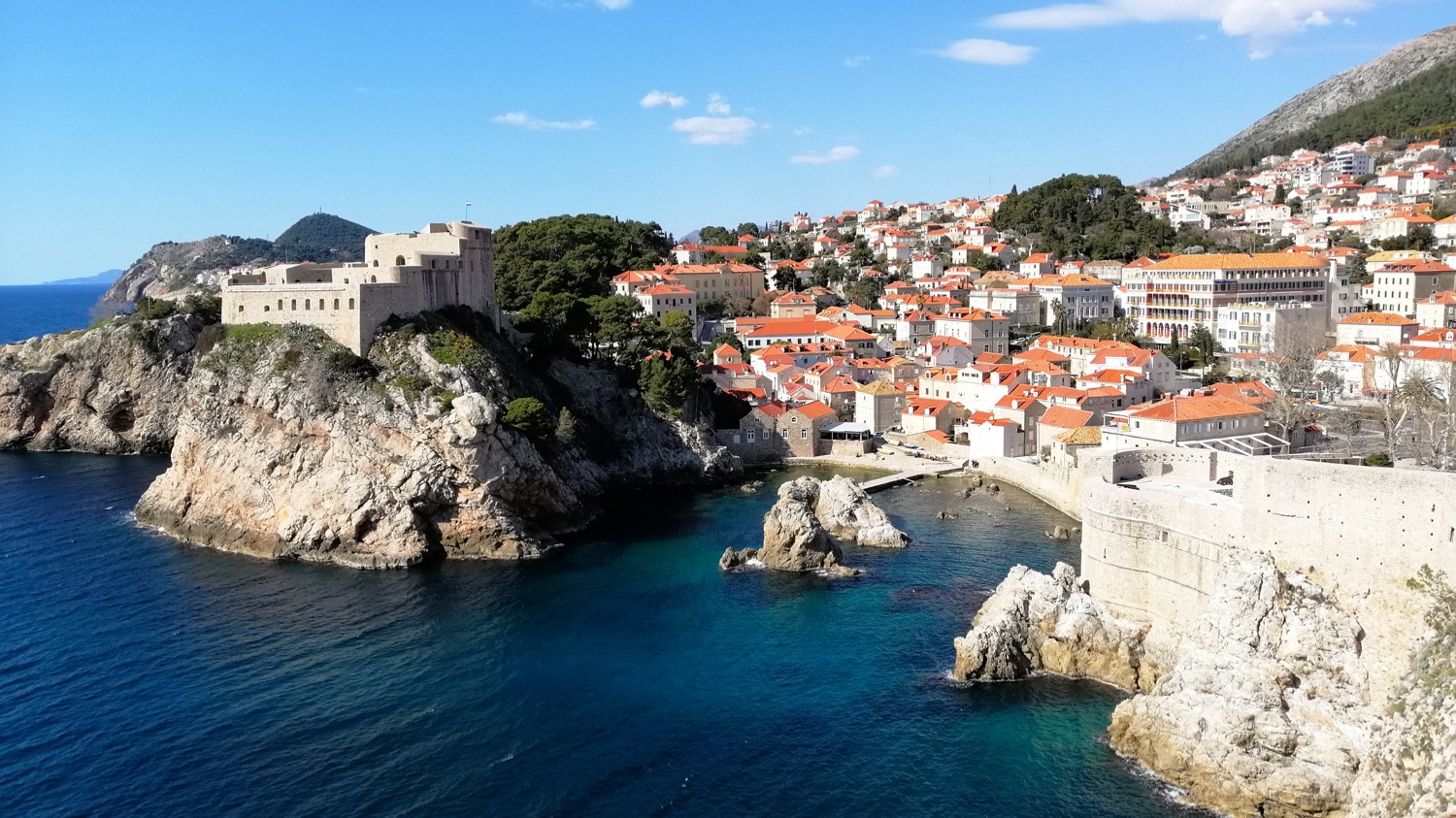 Fort Lovrjenac on its rocky cliff beside Dubrovnik's city walls and hillside houses
