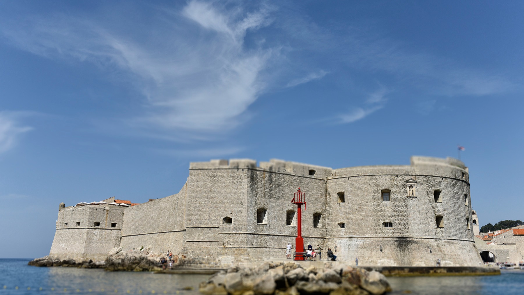 St John's Fortress at the entrance to Dubrovnik's old harbour, with a red harbour light